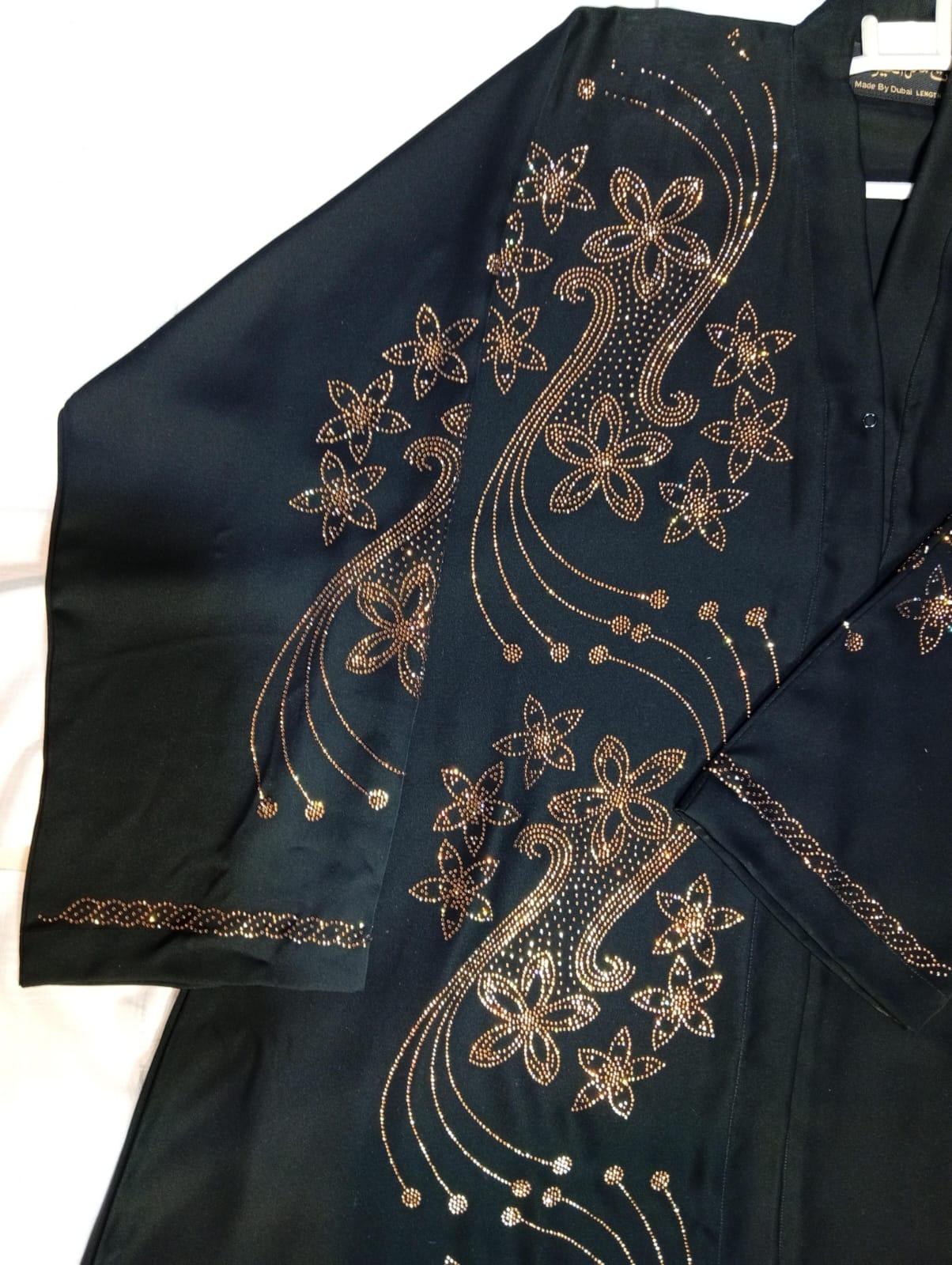 BLACK abaya with gold floral embroidery on a white background